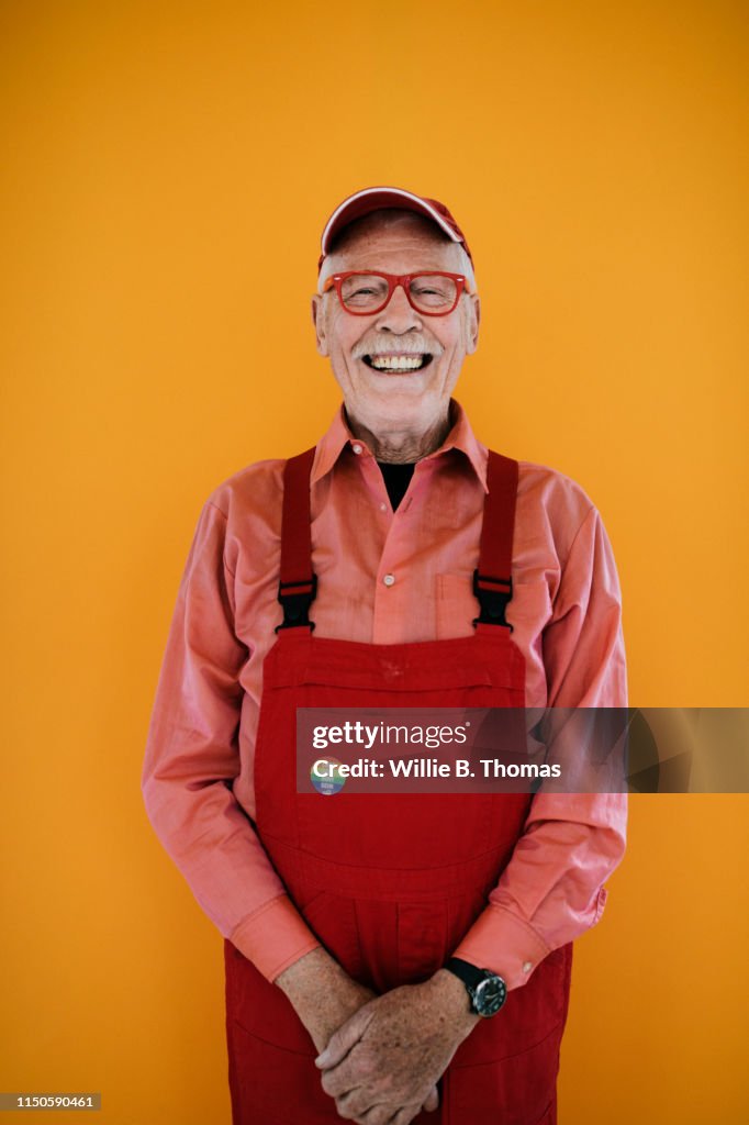 Senior Gay Man in Red Overalls