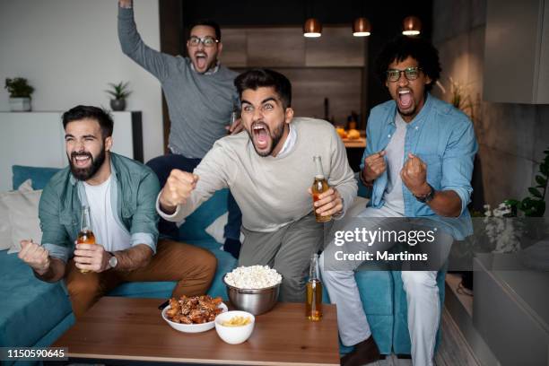 friends watching sport on tv. - sports man cave stock pictures, royalty-free photos & images