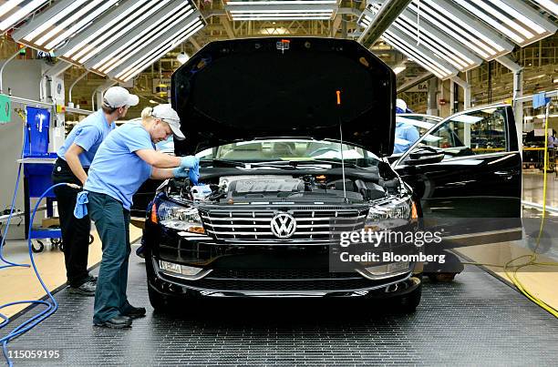 Line inspection workers check out a Volkswagen AG 2012 Passat at the company's factory in Chattanooga, Tennessee, U.S., on Wednesday, June 1, 2011....