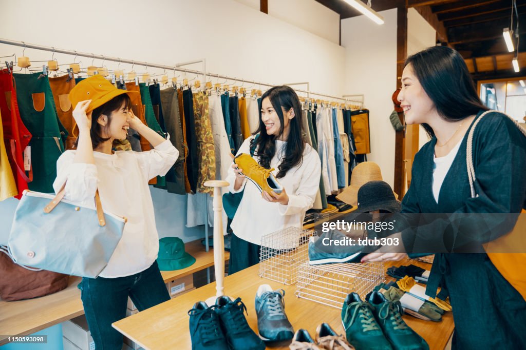 Three women shopping together in a clothing store