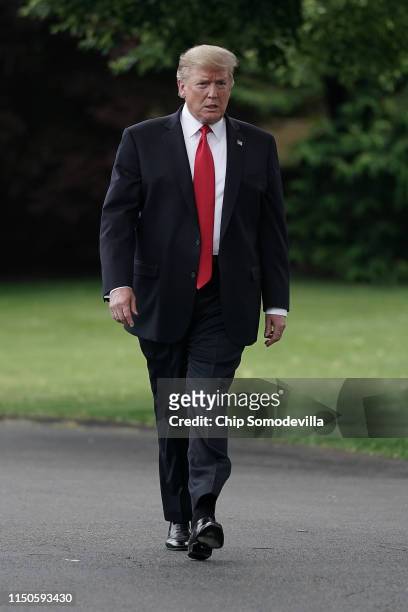 President Donald Trump walks toward journalists as he departs the White House for a campaign rally in Pennsylvania May 20, 2019 in Washington, DC. On...