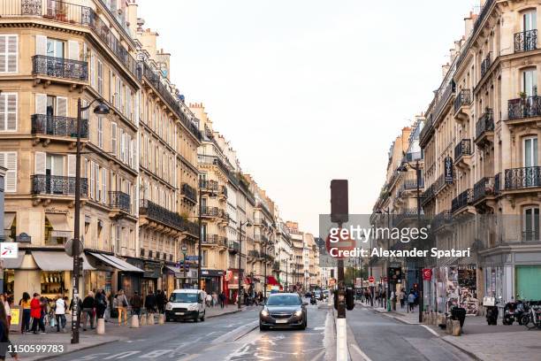 street in le marais district at dusk, paris, france - the marais stock pictures, royalty-free photos & images
