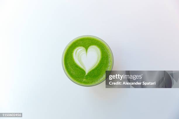 directly above view of green matcha tea latte with heart shaped latte art - green tea leaves stock pictures, royalty-free photos & images