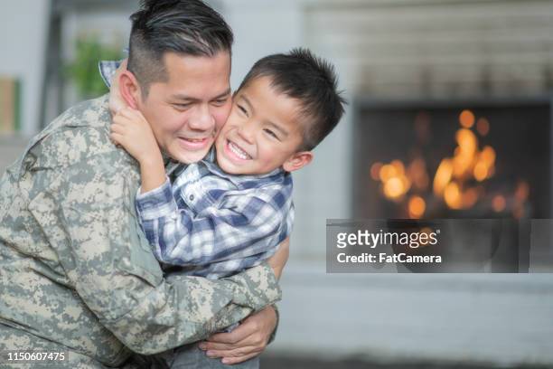 welcoming dad home - filipino family reunion stock pictures, royalty-free photos & images