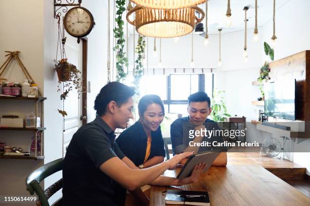 Young Chinese couple with a financial advisor at home