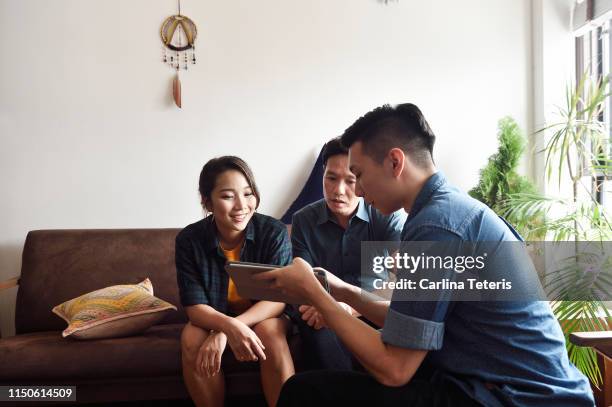 young couple having a consultation at home - obama meets with minister mentor of singapore stockfoto's en -beelden