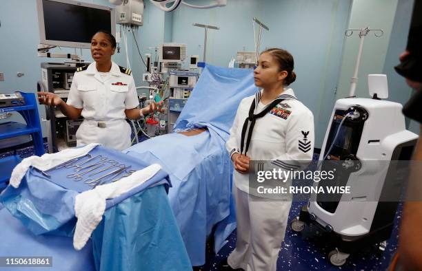 Navel officers explain one of the procedure rooms inside the US Naval hospital ship Comfort docked at the Port of Miami in Miami, Florida on June 18,...