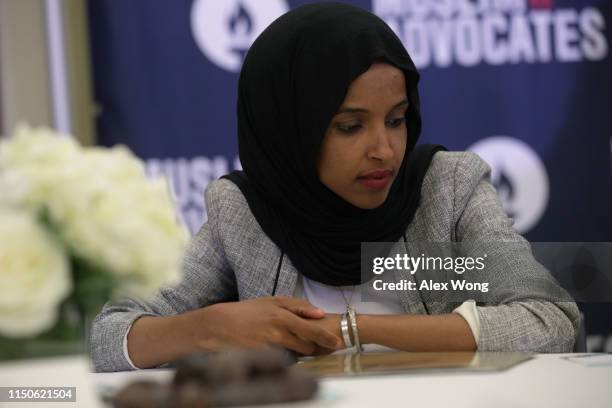 Rep. Ilhan Omar listens to remarks during a congressional Iftar event at the U.S. Capitol May 20, 2019 in Washington, DC. Muslims around the world...