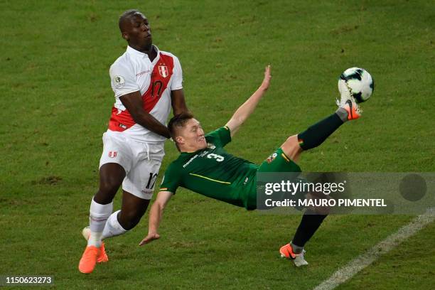 Peru's Luis Advincula and Bolivia's Alejandro Chumacero vie for the ball during their Copa America football tournament group match at Maracana...