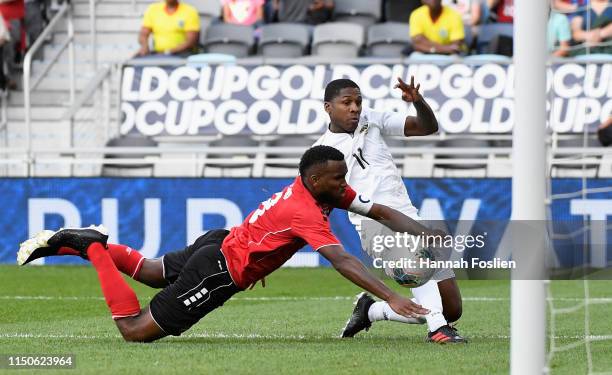 Armando Cooper of Panama shoots the ball to score the first goal of his team against Khaleem Hyland of Trinidad and Tobago during the second half of...