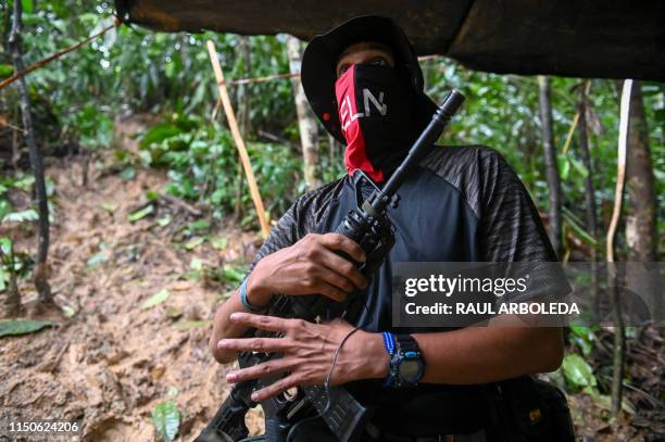 Commander Uriel of the Ernesto Che Guevara front, belonging to the National Liberation Army guerrillas, speaks with AFP during a interview at the...