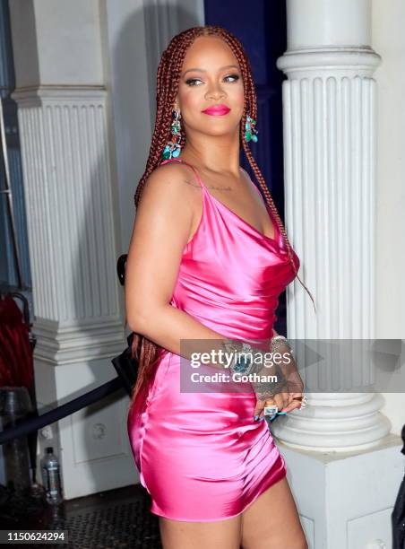 Rihanna wears a hot pink dress when arriving at a Fenty event on June 18, 2019 in New York City.