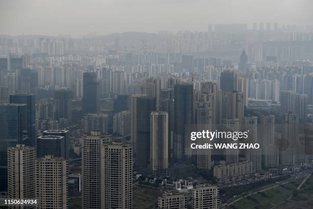 This picture taken on March 22, 2019 shows buildings from the top of Raffles City Chongqing under construction in southwest China's Chongqing...