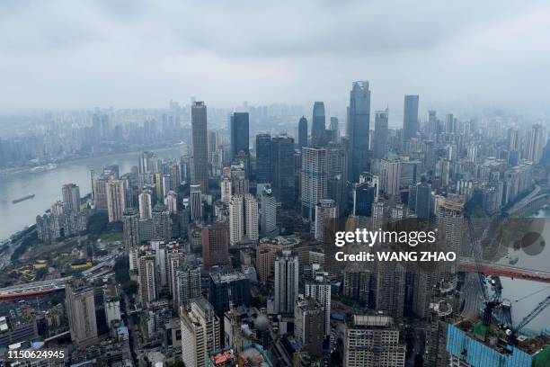 This picture taken on March 22, 2019 shows a skyline of Chongqing from the top of Raffles City Chongqing under construction in southwest China's...