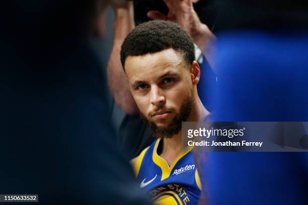Stephen Curry of the Golden State Warriors looks on during a timeout in game four of the NBA Western Conference Finals against the Portland Trail...