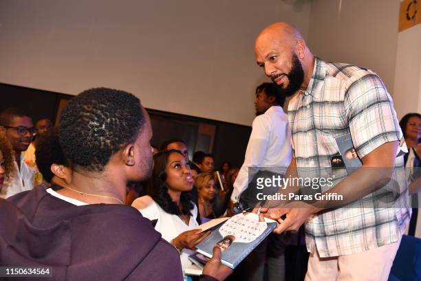 Author/rapper Common signs copies of his new book "Let Love Have the Last Word" during A Conversation With Common & Atlanta Mayor Keisha Lance...