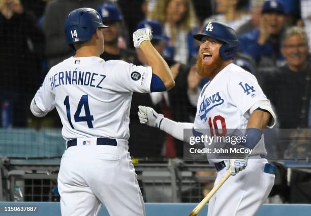 Justin Turner congratulates Enrique Hernandez of the Los Angeles Dodgers on his grand slam home run against the San Francisco Giants in the seventh...