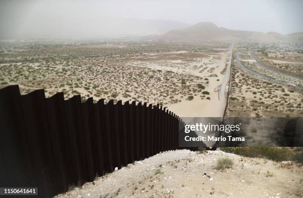 The border barrier between the U.S. And Mexico runs down a hillside on May 20, 2019 as taken from Ciudad Juarez, Mexico. Approximately 1,000 migrants...