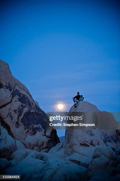 father and daughter watching the moon rise - girl full moon stockfoto's en -beelden