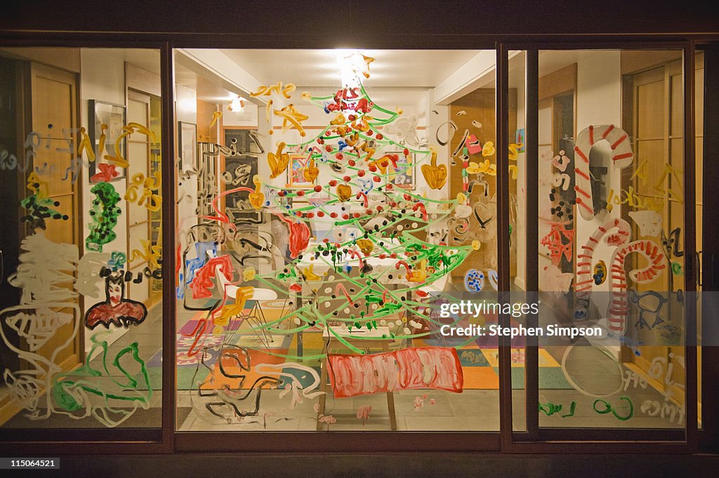 Family home windows painted with Christmas symbols