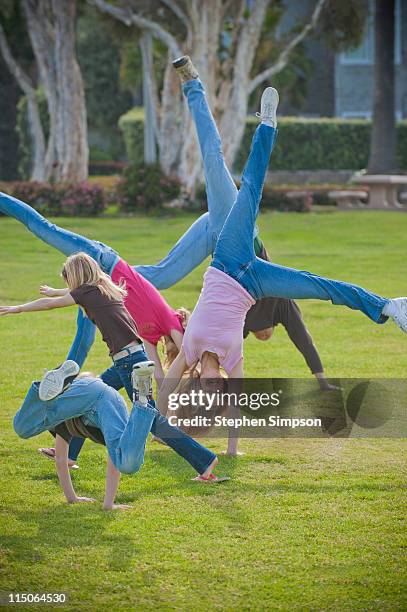 family trying to all do cartwheels together - cartwheel stock pictures, royalty-free photos & images