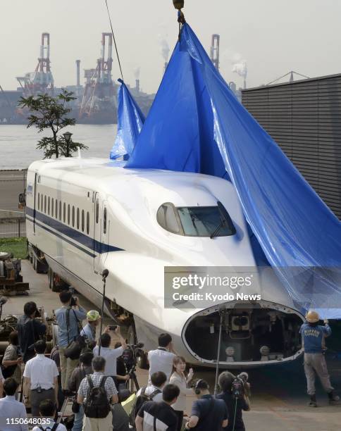 The front car of an N700 shinkansen bullet train is installed on June 19 at Central Japan Railway Co.'s SCMAGLEV and Railway Park museum in Nagoya,...