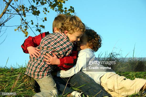 little boys playing like puppies - scraped knee stock pictures, royalty-free photos & images