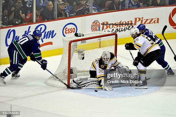 Tim Thomas of the Boston Bruins tends goal against Maxim Lapierre of the Vancouver Canucks during game one of the 2011 NHL Stanley Cup Finals at...