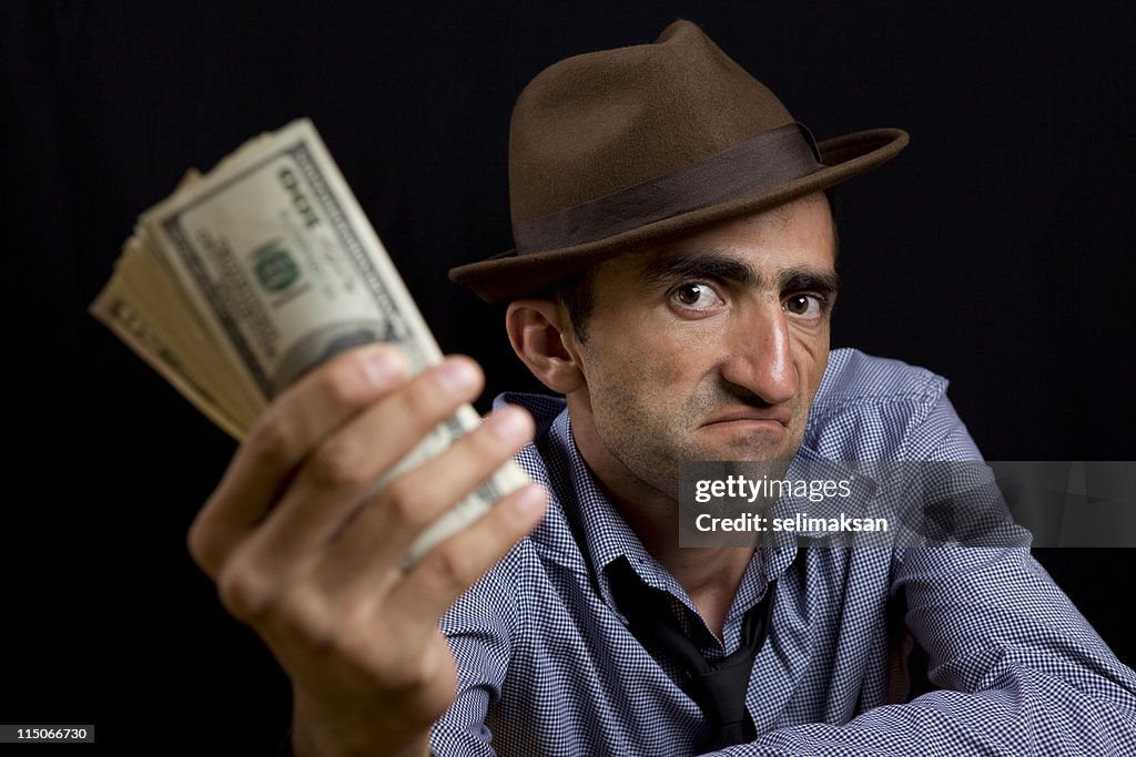 Foto von Mann mit Hut-holding-dollar-Noten in der Hand