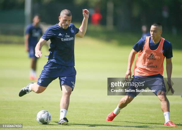 Kyriakos Papadopoulos and Bobby Wood of Hamburger SV are fighting for the ball at Volksparkstadion on June 19, 2019 in Hamburg, Germany.