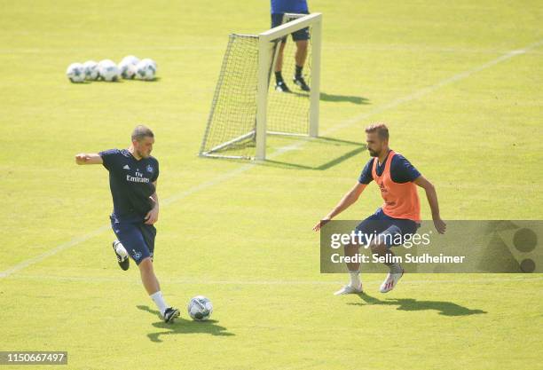 Kyriakos Papadopoulos and Lukas Hinterseer of Hamburger SV are fighting for the ball at Volksparkstadion on June 19, 2019 in Hamburg, Germany.