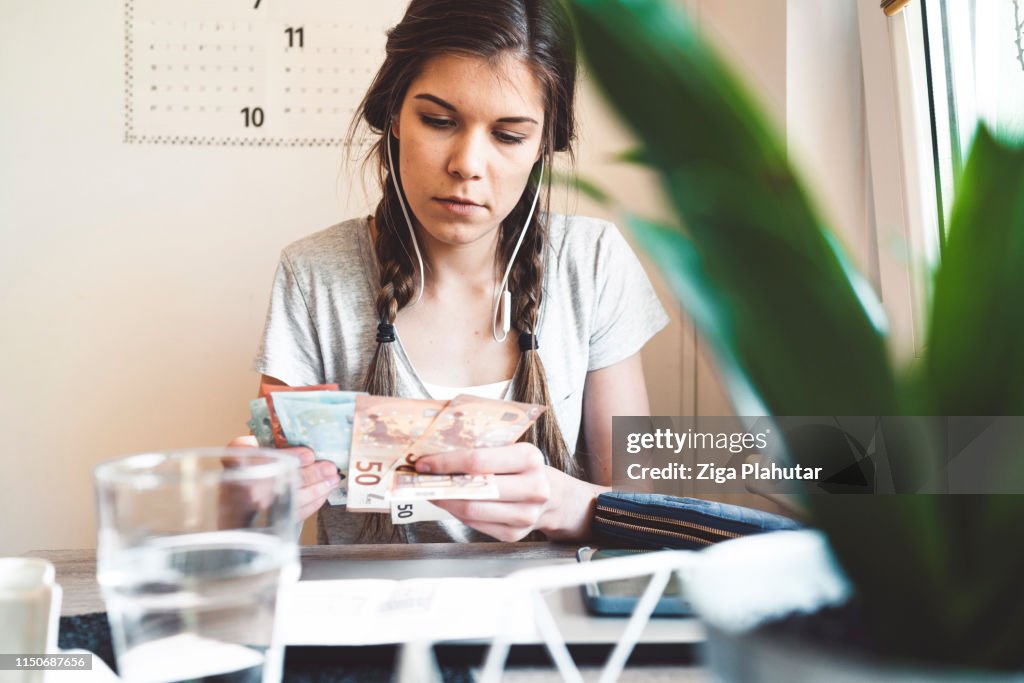 Young woman counting banknotes