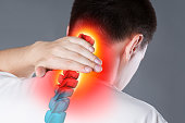 Pain in the spine, a man with backache, injury in the human neck, chiropractic treatments concept