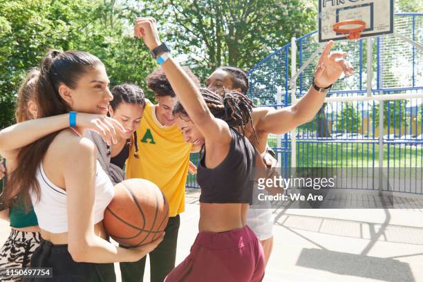 sports team in a huddle celebrating - team sport huddle stock pictures, royalty-free photos & images