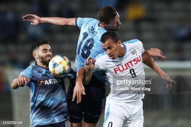 Leandro Damião of Kawasaki Frontale is challenged by Anthony Caceres and Jacob Tratt of Sydney FC during the AFC Asian Champions League match between...