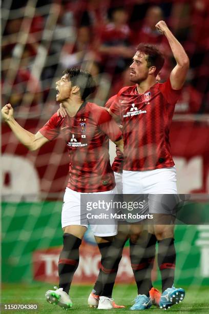 Kazuki Nagasawa of Urawa Red Diamonds celebrates scoring a goal with Maurício Antônio during the AFC Champions League Group G match between Urawa Red...