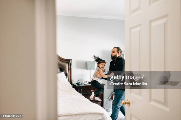 girl jumping from bed into father's arms - bedroom doorway stock pictures, royalty-free photos & images