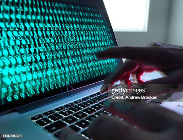 cyber crime, laptop computer being hacked - hacker stock pictures, royalty-free photos & images