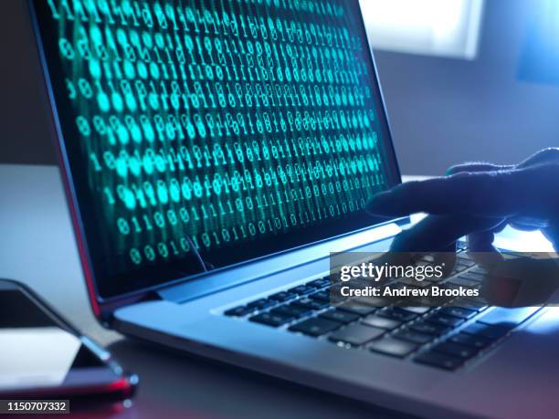 cyber crime, laptop computer being hacked - cyberbullying stock-fotos und bilder