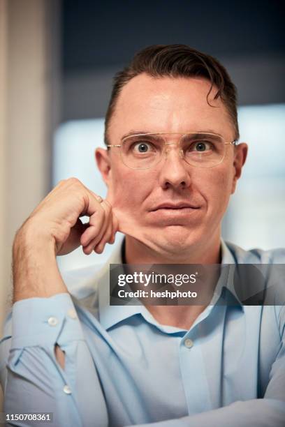 man staring and pinching face - pinching stock pictures, royalty-free photos & images