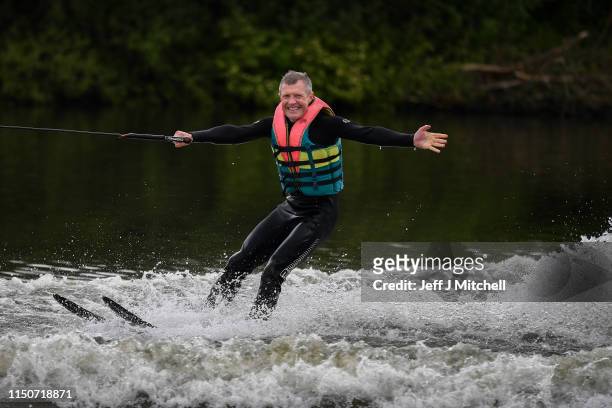 Willie Rennie leader of the Scottish Liberal Democrats, water skies during a European Election campaign event at Water Ski & Wakeboard Scotland on...