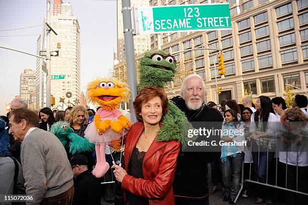 Caroll Spinney and puppeteers pose with "Sesame Street" characters Zoe and Oscar the Grouch at the "Sesame Street" 40th Anniversary temporary street...