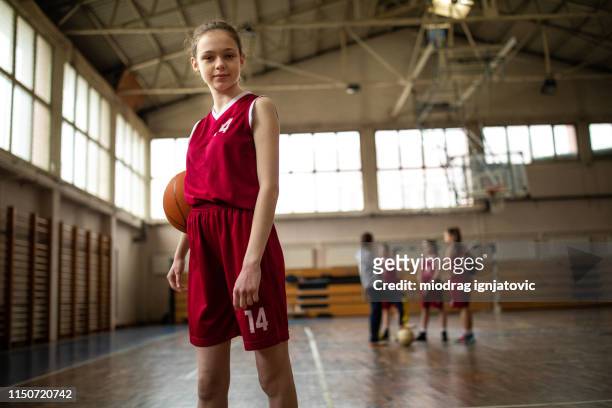 portrait of determined female basketball player - basketball uniform stock pictures, royalty-free photos & images