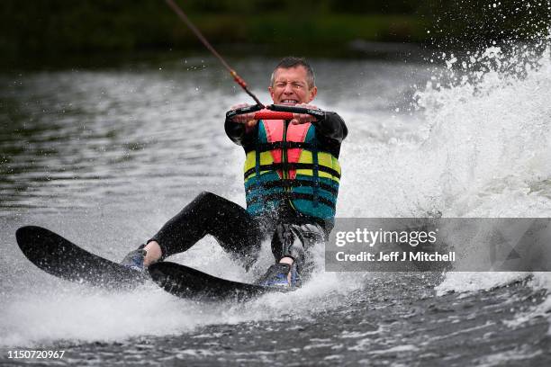 Willie Rennie leader of the Scottish Liberal Democrats, water skies during a European Election campaign event at Water Ski & Wakeboard Scotland on...