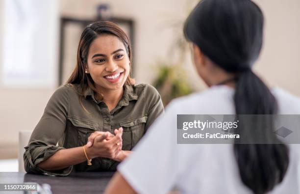 speaking to the doctor - consultation at office desk imagens e fotografias de stock