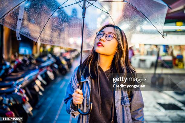 asian girl travelling in taipei on a rainy day - girl rain night stock pictures, royalty-free photos & images