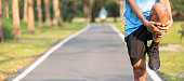 Young athlete man streching in the park outdoor. male runner warm up ready for jogging on the road outside. asian Fitness walking and exercise on footpath in morning. wellness and sport concepts