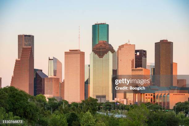 downtown houston texas buildings at dusk - houston stock pictures, royalty-free photos & images