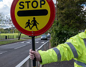 A school crossing guard preparing to stop traffic
