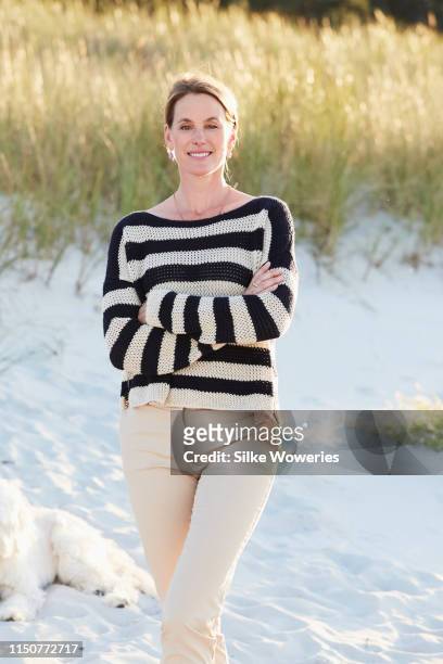 portrait of a middle-aged woman at the beach at sunset - portrait of a woman 40 50 summer stock pictures, royalty-free photos & images